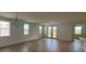 Bright living room with lots of natural light, hardwood floors and access to backyard at 707 Junonia Blvd, New Smyrna Beach, FL 32168