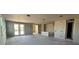 Spacious living room featuring double doors to the back with unfinished walls and concrete floors at 707 Junonia Blvd, New Smyrna Beach, FL 32168
