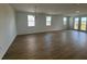Bright living room with lots of natural light, hardwood floors and access to backyard at 707 Junonia Blvd, New Smyrna Beach, FL 32168