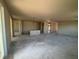 Large living room area with unfinished walls and concrete floors, ready for customization at 707 Junonia Blvd, New Smyrna Beach, FL 32168
