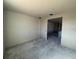 Large living area with unfinished walls and concrete floors, great potential for personalization at 707 Junonia Blvd, New Smyrna Beach, FL 32168