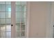 Home office with glass french doors and hardwood floors at 707 Junonia Blvd, New Smyrna Beach, FL 32168