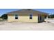 This home has a covered outdoor area with sliding glass doors at 707 Junonia Blvd, New Smyrna Beach, FL 32168