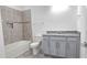 Bathroom featuring shower-tub combo, gray vanity with granite countertop, and tile flooring at 726 Coral Reef Way, Daytona Beach, FL 32124