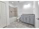 Bathroom featuring shower-tub combo, gray vanity with granite countertop, and tile flooring at 726 Coral Reef Way, Daytona Beach, FL 32124