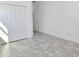 Bright bedroom with gray tile flooring, a closet and an adjacent door at 726 Coral Reef Way, Daytona Beach, FL 32124