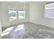 Bright bedroom with gray tile flooring and two large windows providing plenty of natural light at 726 Coral Reef Way, Daytona Beach, FL 32124