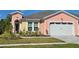 Charming single Gathering home with a two-car garage and beautifully landscaped front yard at 726 Coral Reef Way, Daytona Beach, FL 32124
