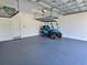Spacious garage featuring overhead storage racks and a golf cart at 726 Coral Reef Way, Daytona Beach, FL 32124