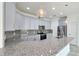 Modern kitchen showcasing gray cabinets, granite countertops, and stainless steel appliances at 726 Coral Reef Way, Daytona Beach, FL 32124