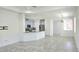Open living space featuring tile flooring, recessed lighting, a kitchen with a breakfast bar, and natural light at 726 Coral Reef Way, Daytona Beach, FL 32124