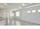 Open living space with tray ceiling, ceiling fan, tile floors, recessed lighting, and large windows at 726 Coral Reef Way, Daytona Beach, FL 32124