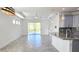 Open-concept living room featuring tile floors, recessed lighting, and a large sliding glass door to the backyard at 726 Coral Reef Way, Daytona Beach, FL 32124