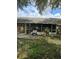 Backyard view featuring a screened porch and a lawn at 837 Pebble Creek Cir, Orlando, FL 32824