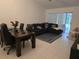 Comfortable living room area with a sectional sofa, dining table and sliding glass door at 837 Pebble Creek Cir, Orlando, FL 32824