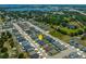 An aerial view showing the home's neighborhood with ponds and greenery in the distance at 871 Orleans Dr, Eagle Lake, FL 33839