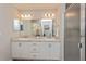 Beautiful bathroom featuring double sink vanity, a large mirror and a glass-enclosed shower at 871 Orleans Dr, Eagle Lake, FL 33839