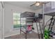 Charming bedroom with bunkbeds, carpeted floors, storage drawers and bright window at 871 Orleans Dr, Eagle Lake, FL 33839