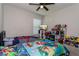 Colorful bedroom with two beds, ceiling fan, and plenty of toy storage at 871 Orleans Dr, Eagle Lake, FL 33839