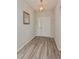 Inviting entryway featuring wood-look floors and a stylish light fixture above the front door at 871 Orleans Dr, Eagle Lake, FL 33839