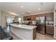 Spacious open kitchen with stainless steel appliances, a large island, and a dining area at 871 Orleans Dr, Eagle Lake, FL 33839