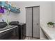 Well-organized laundry room with modern washer and dryer and overhead storage shelves at 871 Orleans Dr, Eagle Lake, FL 33839
