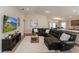 Spacious living room showcasing a comfortable leather sectional and modern decor at 871 Orleans Dr, Eagle Lake, FL 33839