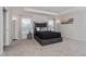Spacious main bedroom with tray ceiling, neutral walls, carpet floors, and large windows with views at 871 Orleans Dr, Eagle Lake, FL 33839