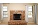 Classic brick fireplace flanked by windows, offering warmth and charm at 984 Dinero Dr, Winter Springs, FL 32708