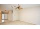 Open-concept living room with neutral paint, carpet, and ceiling fan fixture at 984 Dinero Dr, Winter Springs, FL 32708