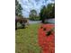 Well-maintained backyard featuring a lush lawn, flower bed, and a privacy fence, perfect for outdoor enjoyment at 107 Hilltop Dr, Longwood, FL 32750
