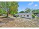 Expansive backyard featuring a screened patio and mature trees, perfect for outdoor living and entertaining at 107 Hilltop Dr, Longwood, FL 32750