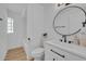 Modern bathroom featuring a shower, a vanity with black hardware, and a round mirror at 107 Hilltop Dr, Longwood, FL 32750