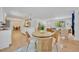 Dining area featuring wooden table, woven chairs, and views into the kitchen and living spaces at 107 Hilltop Dr, Longwood, FL 32750