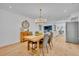 Light-filled dining room features a modern chandelier and seamlessly connects to the kitchen and living areas at 107 Hilltop Dr, Longwood, FL 32750