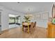 Dining room with wooden table, neutral decor, and a view of the outdoor patio at 107 Hilltop Dr, Longwood, FL 32750