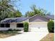 Charming single-story home with a well-manicured lawn, attached two car garage and a modern roof at 107 Hilltop Dr, Longwood, FL 32750