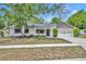 Charming single-story home with well-maintained lawn, mature trees, and a two-car garage at 107 Hilltop Dr, Longwood, FL 32750