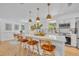 Kitchen island with seating, modern appliances, a view of the backyard, and an open layout at 107 Hilltop Dr, Longwood, FL 32750