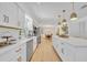 Kitchen with stainless steel appliances, bright white cabinets, and an island with seating at 107 Hilltop Dr, Longwood, FL 32750