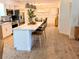 Bright, open kitchen featuring a large island with seating, stainless steel appliances, and modern light fixtures at 107 Hilltop Dr, Longwood, FL 32750