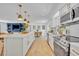 Bright, open kitchen featuring a large island, stainless steel appliances, and modern white cabinets at 107 Hilltop Dr, Longwood, FL 32750