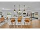 Kitchen island featuring white cabinets, pendant lighting, quartz countertop, and seating for three at 107 Hilltop Dr, Longwood, FL 32750