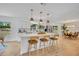 Kitchen featuring an island with seating, modern appliances, and an adjoining dining area at 107 Hilltop Dr, Longwood, FL 32750