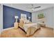 Comfortable main bedroom featuring an accent wall, ceiling fan, and natural light from the window at 107 Hilltop Dr, Longwood, FL 32750