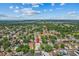 An aerial view of the property and neighborhood with lush trees and blue skies at 1240 Falconcrest Blvd, Apopka, FL 32712