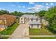 An aerial view showcasing a two-story home with a long driveway and green lawn at 1240 Falconcrest Blvd, Apopka, FL 32712