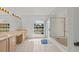 Well lit primary bathroom offers dual sinks, vanity space, tub and walk in shower at 1240 Falconcrest Blvd, Apopka, FL 32712