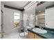 Accessible bathroom with a walk-in shower, safety rails, and a vanity, ensuring comfort and convenience at 1240 Falconcrest Blvd, Apopka, FL 32712