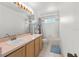 Bathroom featuring double sinks, a shower and tub combination, and ample lighting at 1240 Falconcrest Blvd, Apopka, FL 32712